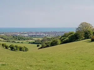A view over Worthing to the sea from the South Downs National Park near to Cissbury Ring, West Sussex, UK