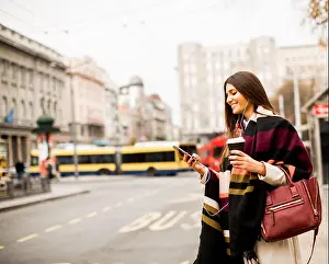 Calling Prints: View at young woman hailing a taxi on the street in the city