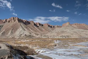 Snow Capped Prints: Village Near Band-e Amir Lake With Frozen Water And Mountains In The Background