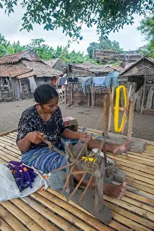 Spinning Prints: Village scene with a woman spinning yarn in Sangean village
