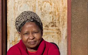 Botswana Prints: village single african woman with headscarf sited in front of the house