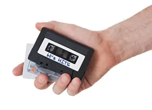 Analogue Prints: Vintage audio cassette tape, isolated on white background, 60's hits