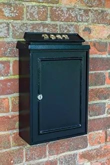 Cast Iron Prints: Vintage black post box or letterbox on a brick wall in England, UK