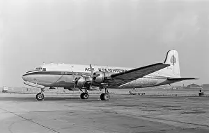 1965 Prints: A vintage black and white photograph showing a Douglas DC-4 airliner