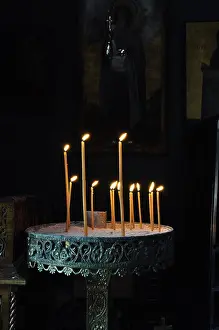 Holder Prints: Vintage byzantine manouali candle stand in dark orthodox church interior