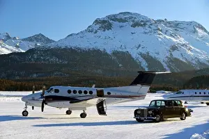 Take Off Prints: A vintage car Rolls Royce and private jets in the airport of Engadine St Moritz