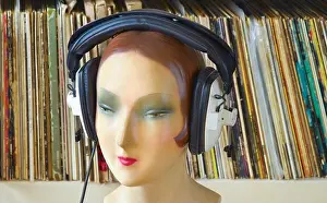 Covers Prints: vintage display dummy, mannequin wearing professionell headphones vinyl records in the background