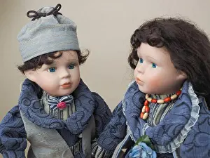 Porcelain Prints: Vintage porcelain dolls blue-eyed boy and girl with dark hair in gray-blue suits