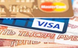 Debit Prints: VISA and Mastercard Debit Card lying over banknotes of russian rubles