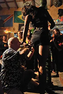 Polynesia Prints: a visitor places money on a dancer at Tongan Bob's where Wednesday night is Fakaleiti night
