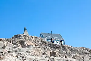 Greenland Prints: Visitors to Ittoqqortoormiit at the bust of Danish explorer and settlement founder Ejnar Mikkelson