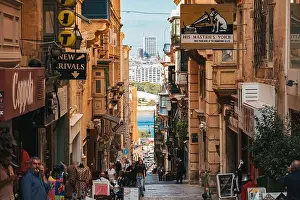 Balconies Prints: Visitors stroll along a vibrant street in Valletta