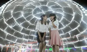 Visitors talk under an installation of LED lights during a light art festival at Huahai Park in Taiyuan city