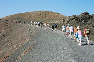 Cyclade Prints: Visitors walking up the volcano on 'Nea Kameni' island near Santorini, Greece