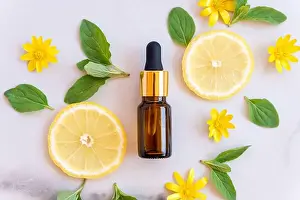 Serum Prints: Vitamin C serum in cosmetic bottle with lemon citrus slices with green leaves on white background