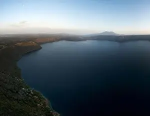 Central American Prints: Volcanic lagoon Apoyo in Nicaragua aerial drone view on sunset orange color