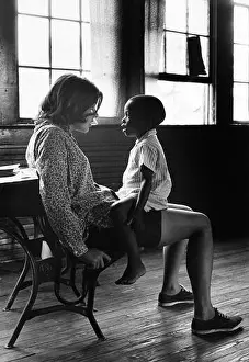 Volunteer for Family of Children, an early 1960s program predating Volunteers in Service to America (VISTA), with a young child in North Carolina