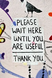 Painted Prints: Please wait here until you are useful sign painted on a wall, Shoreditch, London, UK