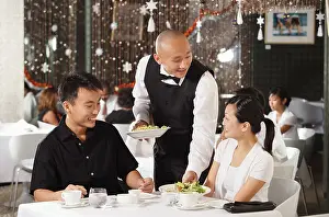 Bending Prints: Waiter serving couple at restaurant