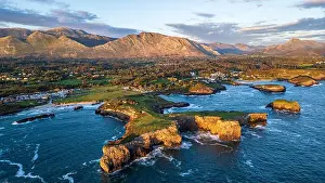 High Angle Prints: Warm golden light envelops the rugged coastline of Llanes