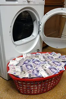 Bank Note Prints: wash basket containing bank notes to be laundered in washing machine, UK