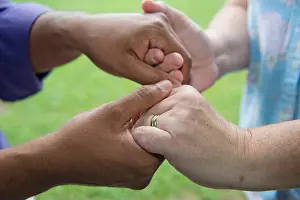 Companionship Prints: Washington DC, July 12, 2013, USA: Hands clasped together in friendship
