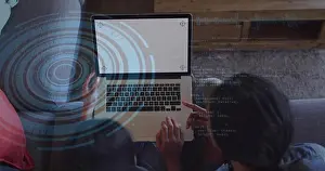 Explaining Prints: Watching mentor-student duo coding and pointing on gray couch at home with laptop