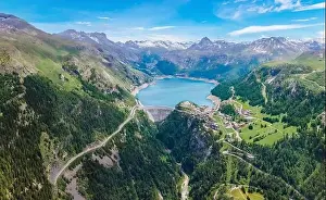 Power Plant Prints: Water dam and blue reservoir lake aerial overview in Alps mountains in summer generating hydroelectricity