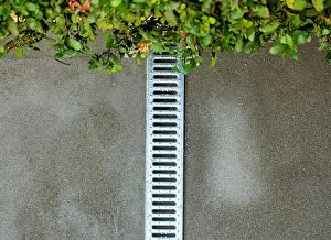 Drainage Prints: Water drainage grate in the garden during the creation of the screed before laying the floor