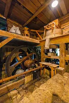 Grinding Prints: Water mill interior showcasing large wooden gears