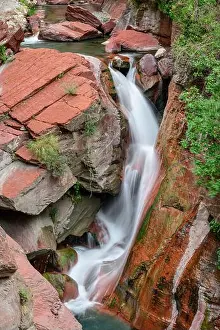 European Alps Prints: Waterfall flowing amidst red Maritime Alps, Mercantour National Park, France