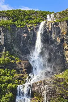Water Body Prints: Waterfall, mountain cliff and green trees on the way to Briksdal or Briksdalsbreen glacier in Olden
