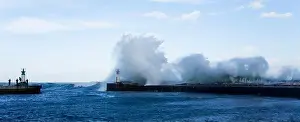 Cape Town Prints: Waves crashing over lighthouse in Kalk Bay Harbour as fishermen brave storm