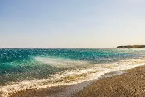 Offshore Prints: Waves of Mediterranean Sea being pushed away from the shore by strong winds coming down from mountains under clear sky