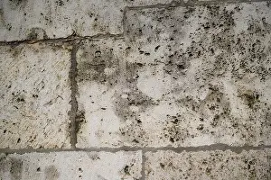 Cobblestone Prints: Weathered sand-lime stone as a brick partially repaired