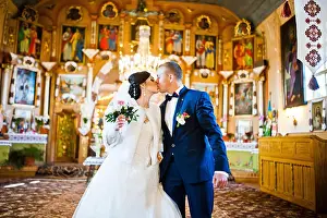 Commitment Prints: Wedding couple kissing at church