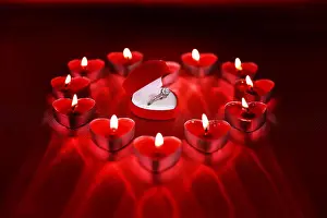 Valentines Prints: Wedding solitaire ring in heart shaped red box with heart shaped candle on red background
