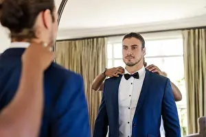 Formalwear Prints: Wedding suits, male friends adjusting bow tie and blue suit in dressing room