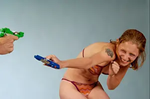 Swimsuit Prints: Wet woman in water pistol fight