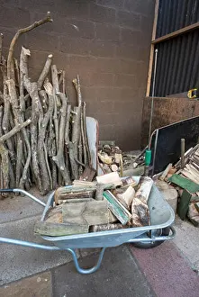 Shed Prints: Wheelbarrow full of logs beside a pile of kindling and a log splitter