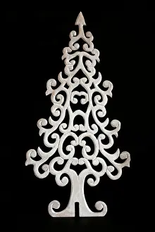 Yuletide Prints: White christmas tree carved out of wood on black background