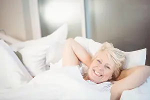 Duvet Prints: White duvet lying smoothly on bed in bedroom, with soft morning light filtering