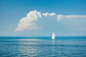 Good Weather Prints: White sailboat on the turquoise water of Lake Constance with a low
