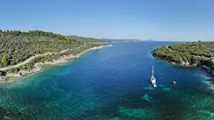 Beach Holiday Prints: White sailing ship yacht at sea in shallow water near shore. Aerial drone view of sailboat