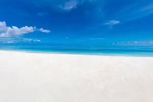 White sand beach and blue sky. Idyllic tropical nature pattern, paradise island landscape, peaceful, tranquil scenery, Sea sand sly concept
