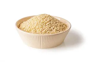 Dressing Prints: White sesame seeds in a beige bowl isolated on a white background