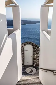 White stairs of the traditional white Greek architecture apartment with a great view on sea, Santorini island, Greece. Summer travel background