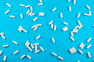 Medicament Prints: White tablets on a blue background with space for text