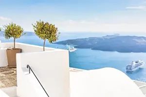 White wash staircases on Santorini Island, Greece. The view toward Caldera sea with cruise ship awaiting. Luxury summer travel, dream vacation