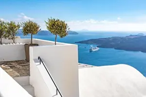 White wash staircases on Santorini Island, Greece. The view toward Caldera sea with cruise ship awaiting. Luxury summer travel, dream vacation